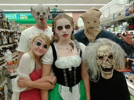 Five people posing in Halloween costumes